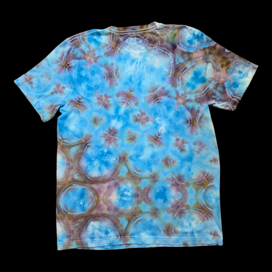 Back of the same shibori tie-dye t-shirt showing mirrored ringed patterns in blue and brown.