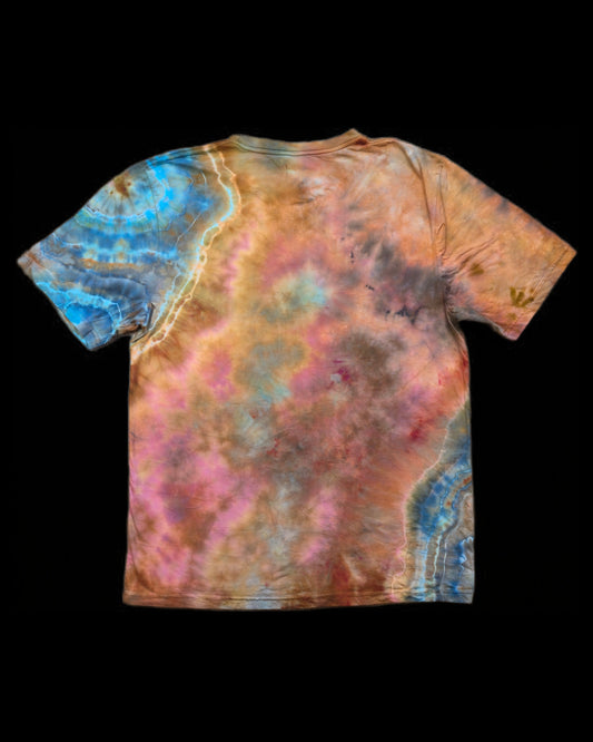 Back of the tee showing a mottled pink and copper wash with a blue geode ring on the left shoulder.