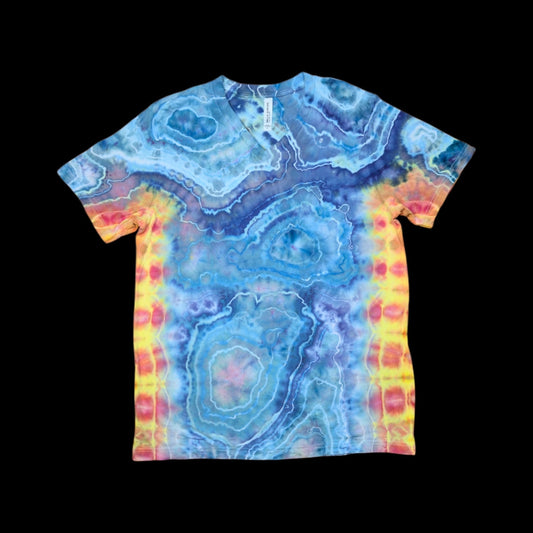 Front of a v-neck tie dye tee with a blue geode pattern and yellow, pink, and orange bursts along the sides.