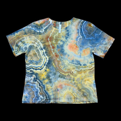 Front of a relaxed women's tee ice-dyed with a blue, gold, rust, and cream geode ring pattern.