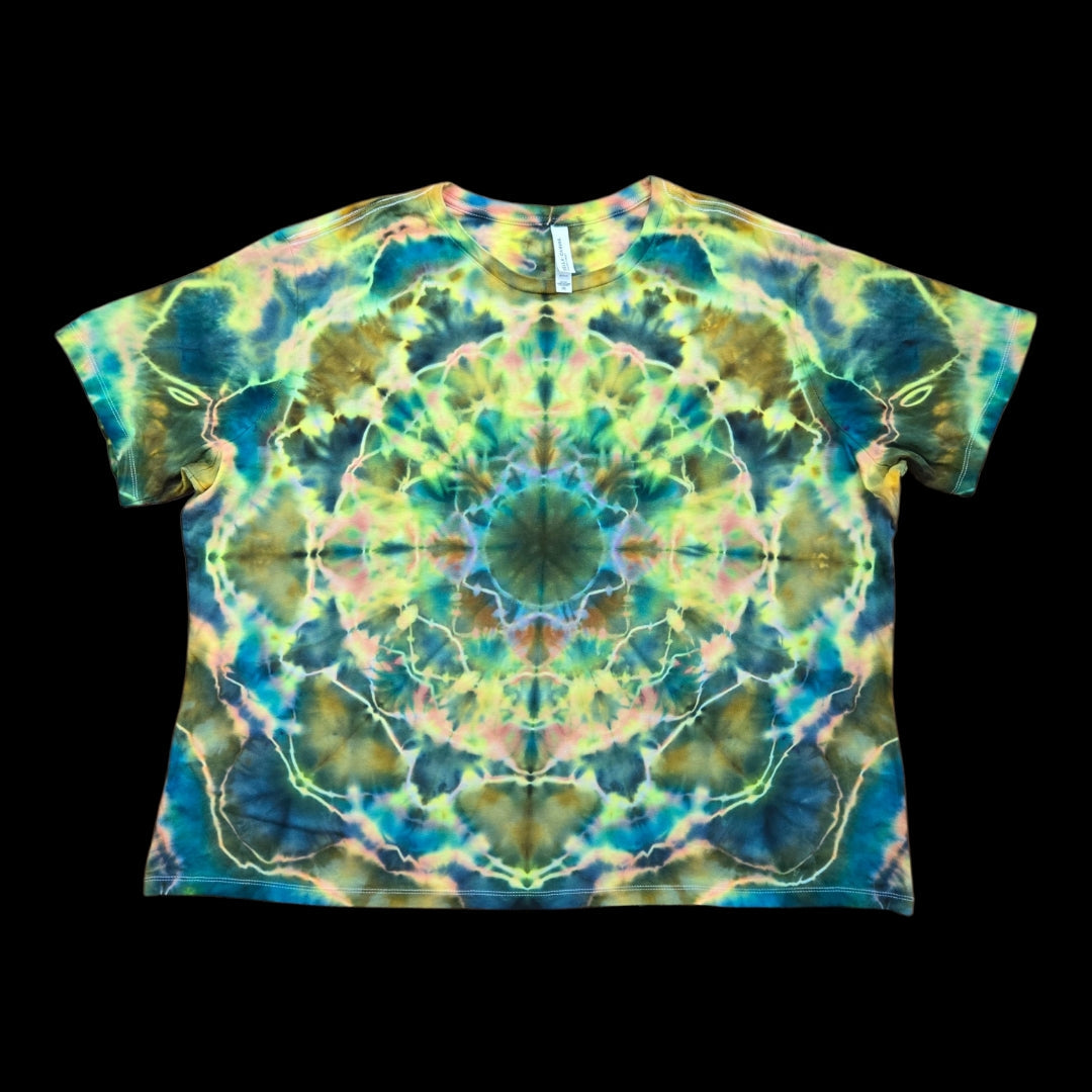 Front of a tie-dyed women's tee with a symmetrical kaleidoscope mandala in teal, green, yellow, and pink.