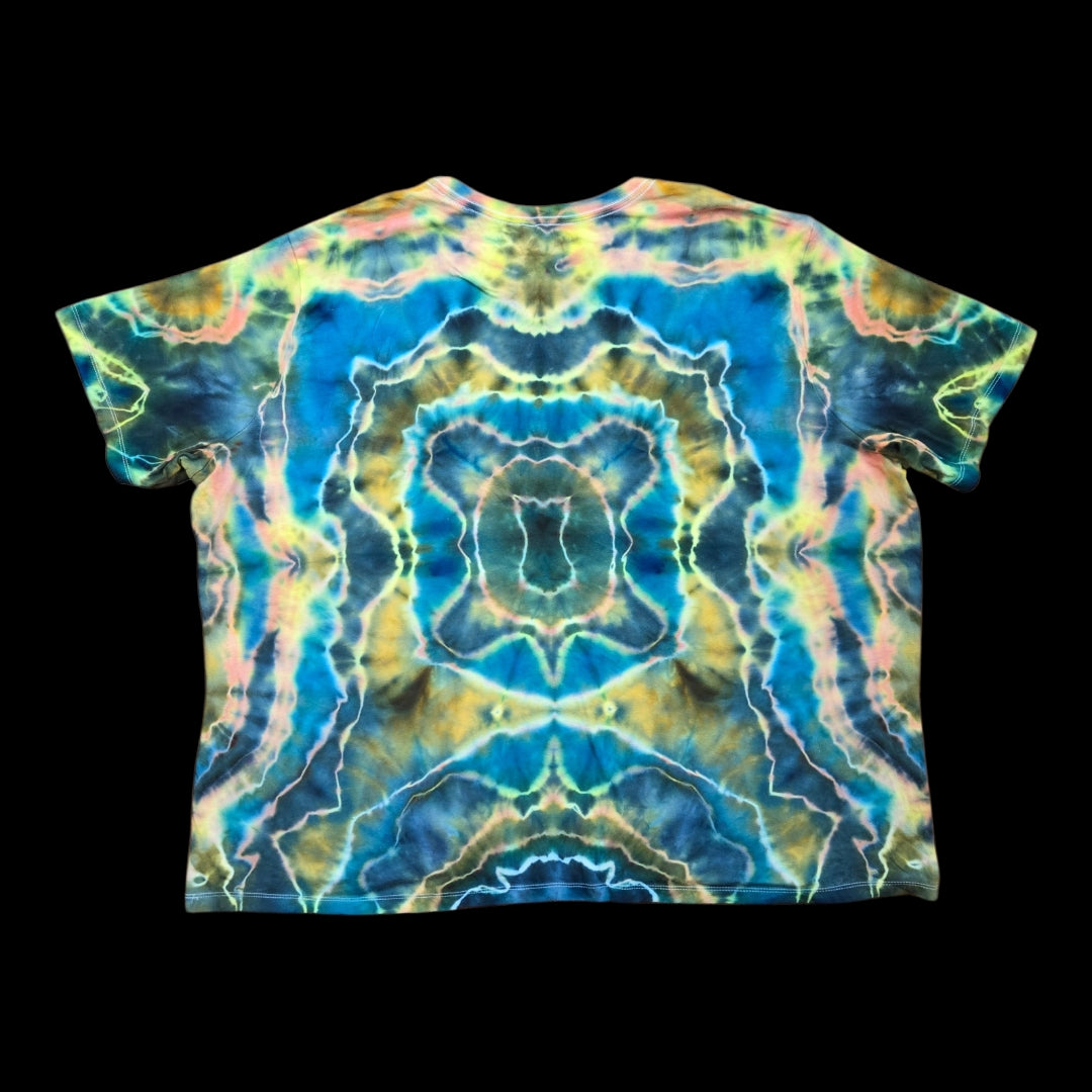 Back of the tie-dyed tee showing a mirrored abstract design in deep blue, golden brown, and pastel pink.