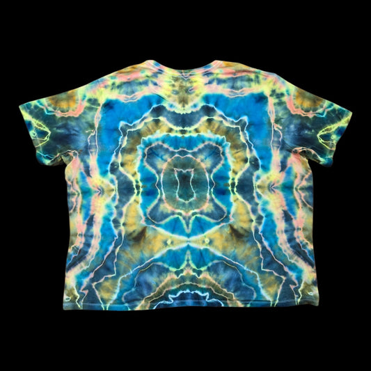 Back of the tie-dyed tee showing a mirrored abstract design in deep blue, golden brown, and pastel pink.