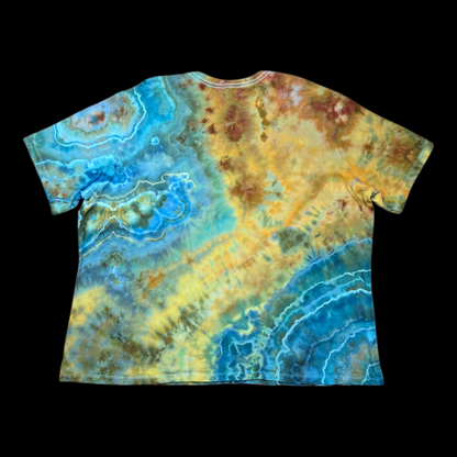 Back of the tie-dye tee showing layered blue and teal geode rings blending into gold and brown crystalline bursts.
