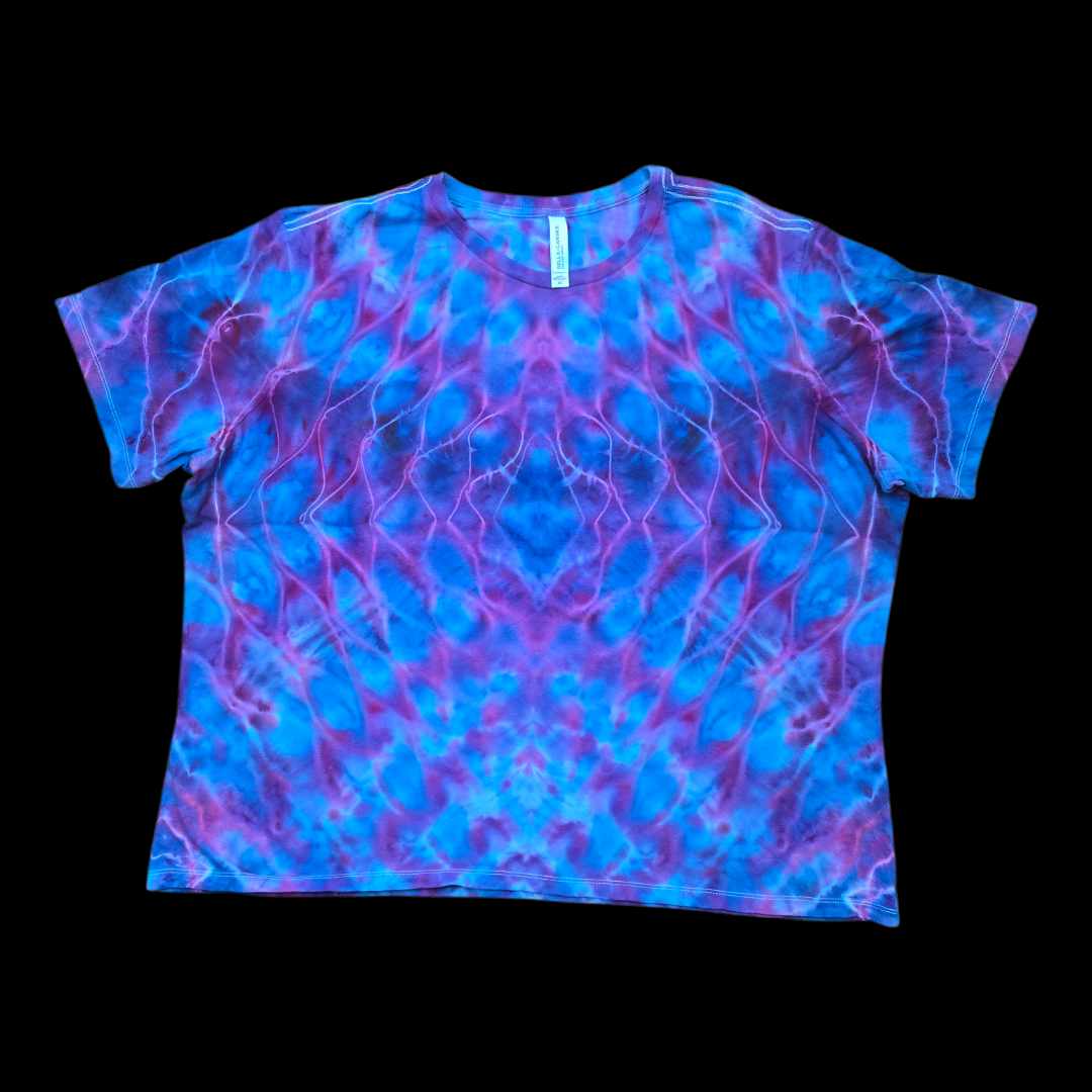 Front of a blue and purple rolled mandala tie-dye women's relaxed tee on a black background.
