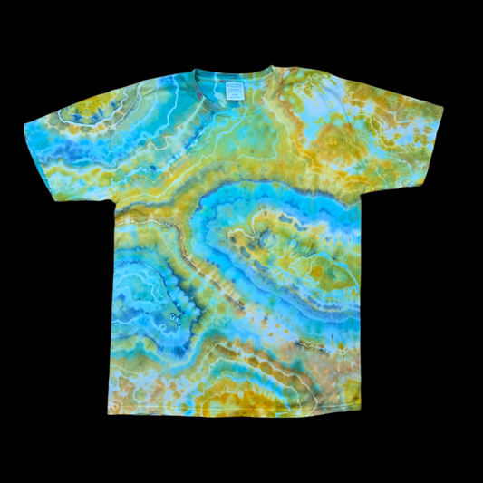 Front of a tie-dyed t-shirt with a turquoise, blue, gold, and green geode ripple pattern.