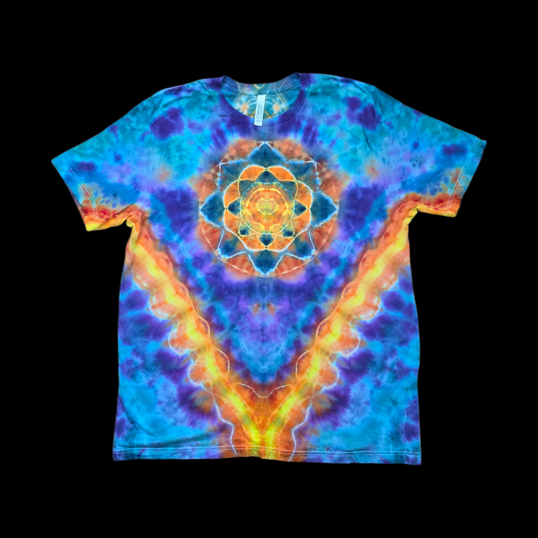 Front of a tie-dyed T-shirt with an orange and yellow mandala on the chest surrounded by blue and purple radiating into a V shape.