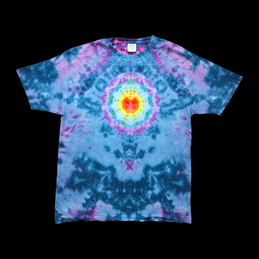 Front of a blue tie-dye tee with a fiery red, orange, and yellow sunburst mandala ringed in turquoise and purple at the chest.