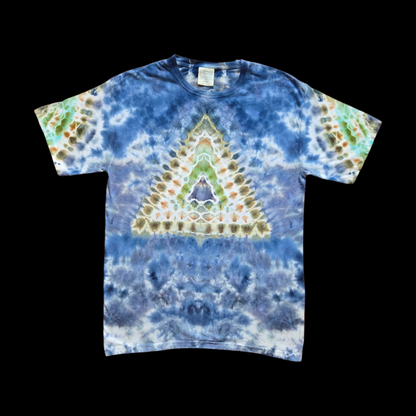Front of a blue tie-dye t-shirt with a centered triangle mandala in green, olive, brown, and orange over a white and blue background.