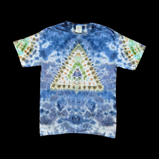 Front of a blue tie-dye t-shirt with a centered triangle mandala in green, olive, brown, and orange over a white and blue background.