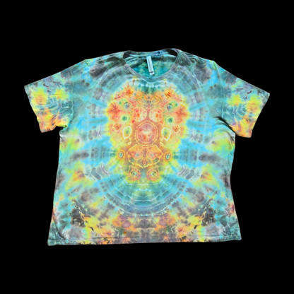 Front of a tie-dyed women's tee showing a symmetrical mandala with orange, yellow, and red center rings surrounded by blue, green, and gray.