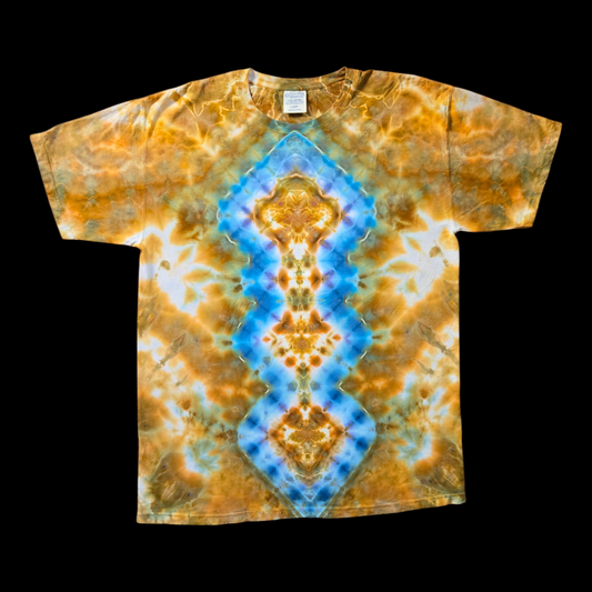 Front of a tie-dyed tee with a vertical blue and gold diamond mandala design over an amber and white background.