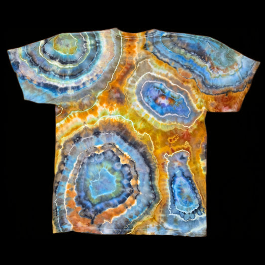 Back of the same tie-dyed t-shirt showing multiple overlapping agate slices in blue, rust orange, and gray with white crystalline edges.