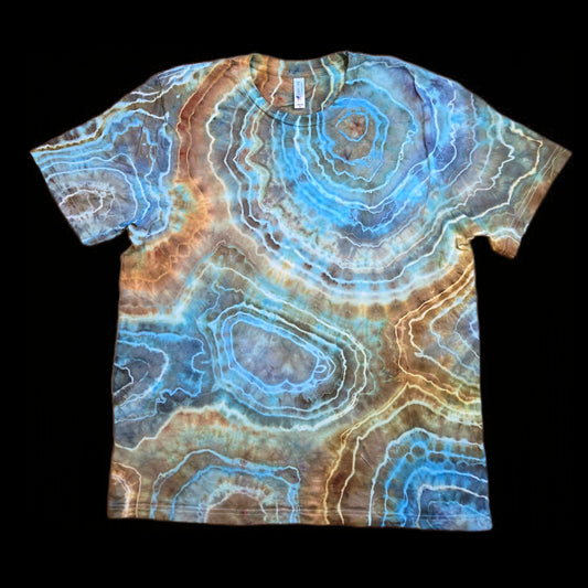 Front of a tie-dyed t-shirt with blue, copper, and brown concentric geode rings and white veins.