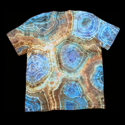 Back of the same t-shirt showing large circular geode formations in aqua, tan, and rust with white outlines.