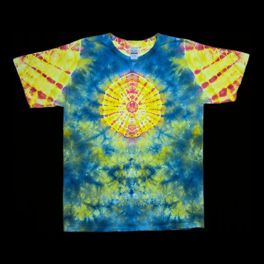 Front of a tie-dyed tee with a yellow and red mandala in the center on a blue and green background.