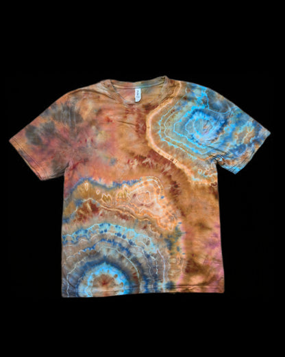 Front of a copper and brown tie-dyed tee with turquoise and blue concentric geode rings.
