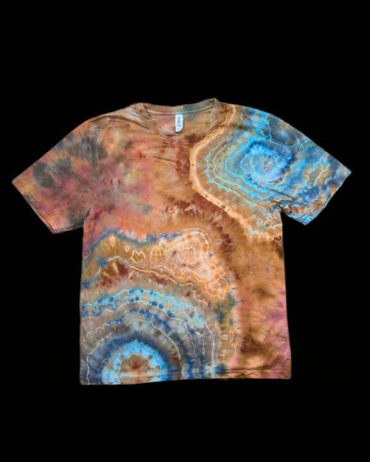 Front of a copper and brown tie-dyed tee with turquoise and blue concentric geode rings.