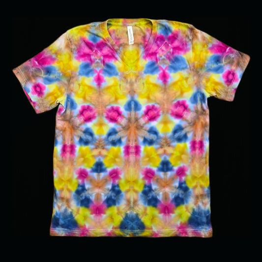 Front of a v-neck t-shirt with a mirrored shibori fold tie-dye pattern in magenta, yellow, steel blue, and orange repeating in rows.
