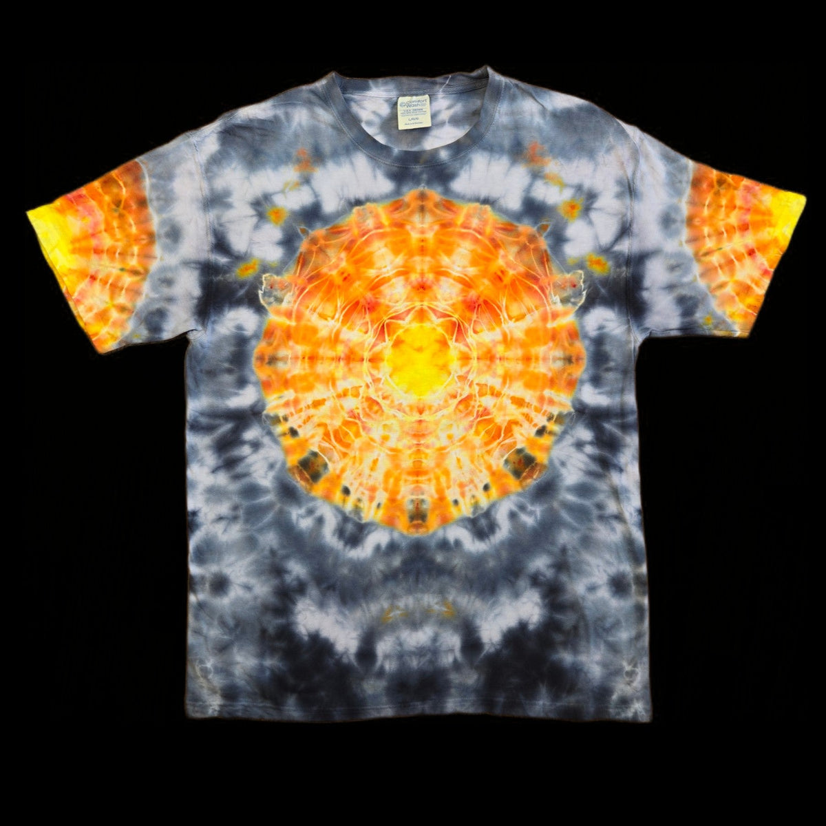 Front of shirt displays a radial mandala pattern in orange and yellow with white highlights, centered on a gray and black tie-dye field.